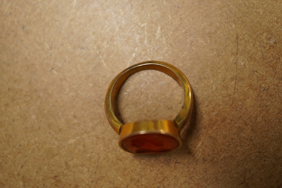 A yellow metal and intaglio carnelian set ring, the matrix carved with the bust of a gentleman to sinister, gross weigh 5.2 grams.